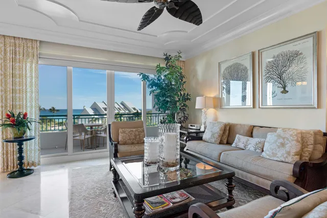 a living room with lots of furniture and a chandelier