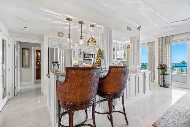 a large kitchen with a lot of counter space and wooden floor