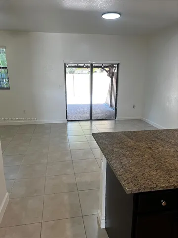 a large kitchen with a sink and large stainless steel appliances