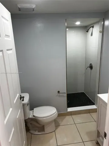 a view of a hallway with stainless steel appliances a counter top space