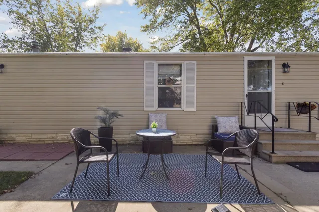a backyard of a house with table and chairs