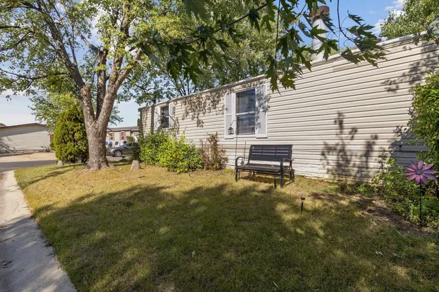 a backyard of a house with table and chairs