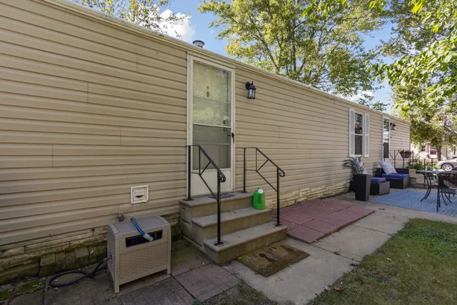 a view of a patio with table and chairs and wooden fence