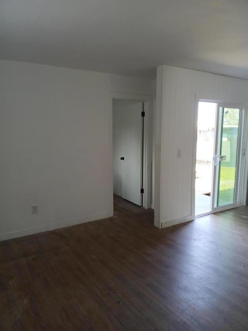 665 West Tyler Island Bridge Road Isleton, CA 95641 - Photo 11 of 19 an empty room with wooden floor and windows