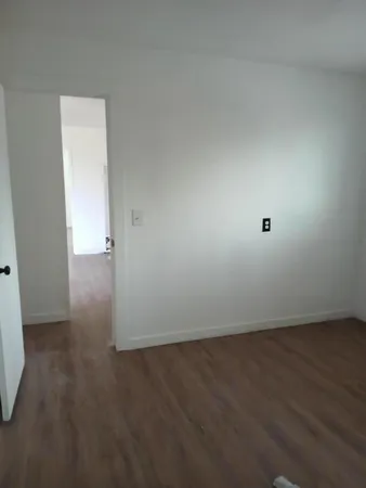 an empty room with wooden floor