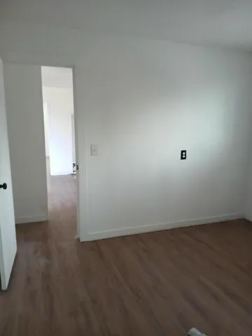 an empty room with wooden floor