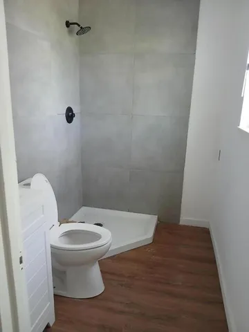a bathroom with a toilet and a shower
