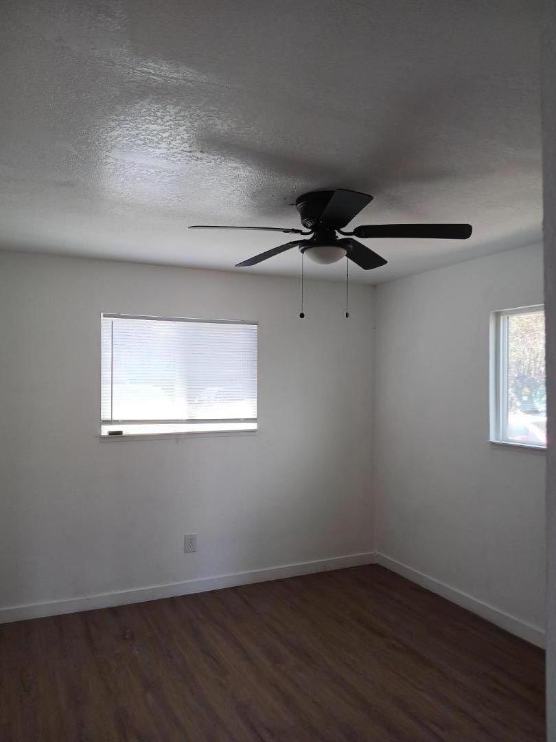 665 West Tyler Island Bridge Road Isleton, CA 95641 - Photo 10 of 19 an empty room with wooden floor fan and windows