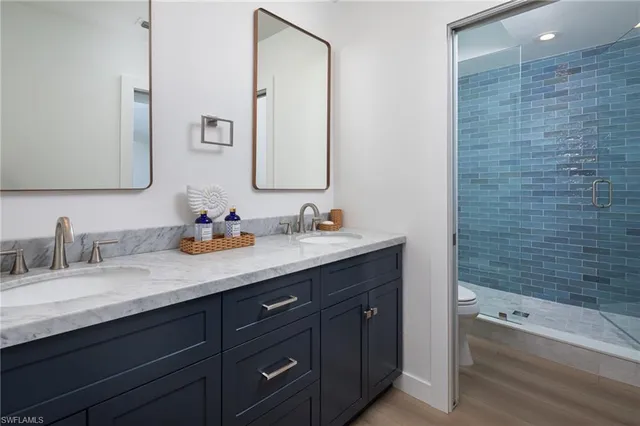 a bathroom with a granite countertop sink mirror and bathtub
