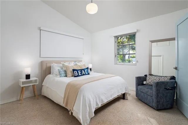 a bedroom with a bed and window