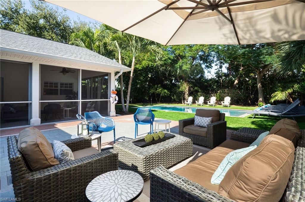 339 4th Avenue North Naples, FL 34102 - Photo 30 of 48 a view of a patio with couches chairs and a yard