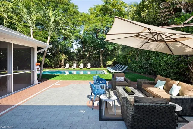 a view of backyard with seating area and trees