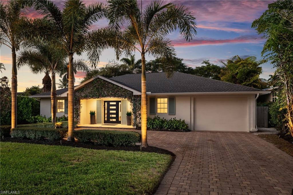 339 4th Avenue North Naples, FL 34102 - Photo 32 of 48 a front view of a house with a yard and garage