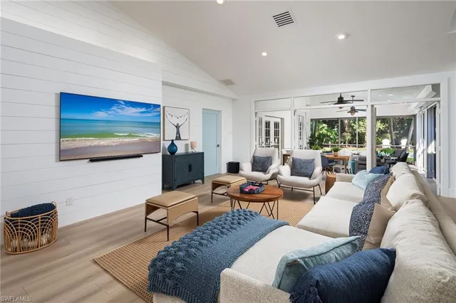 a living room with furniture a rug and a large window