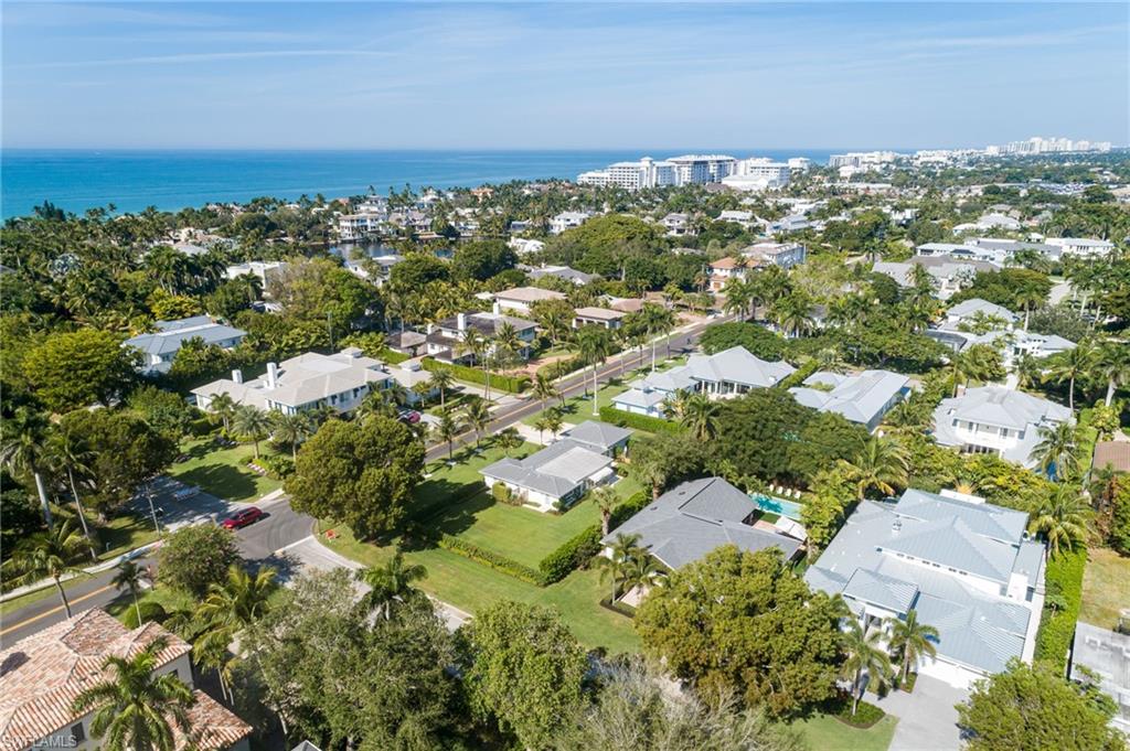 339 4th Avenue North Naples, FL 34102 - Photo 46 of 48 an aerial view of residential houses with outdoor space and trees