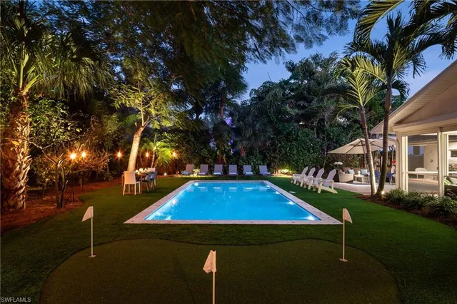a view of yard with swimming pool and green space