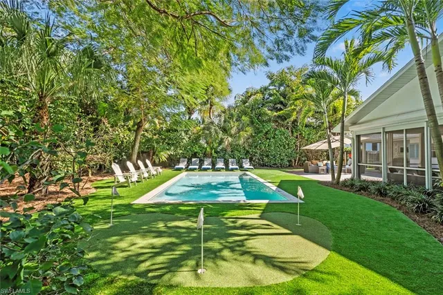 a view of a backyard with swimming pool