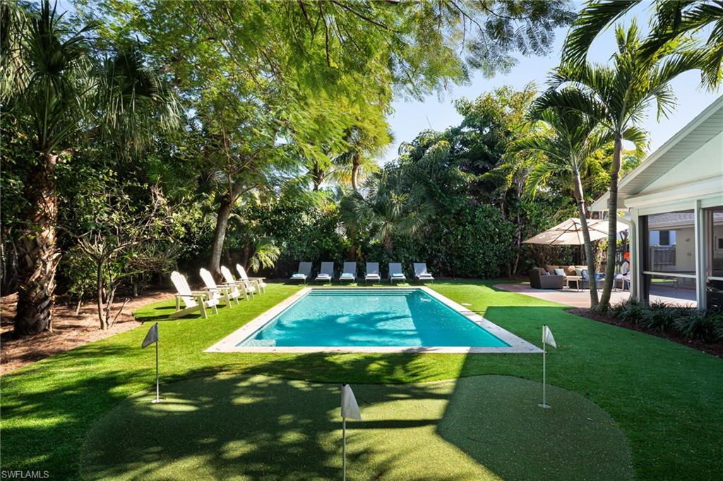 339 4th Avenue North Naples, FL 34102 - Photo 10 of 48 a view of a backyard with swimming pool and seating