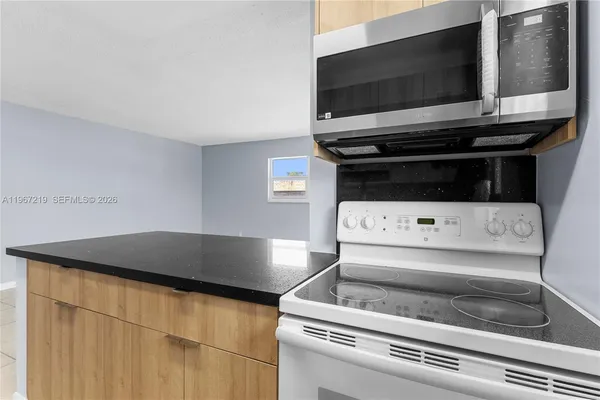 a kitchen with a stove and a microwave