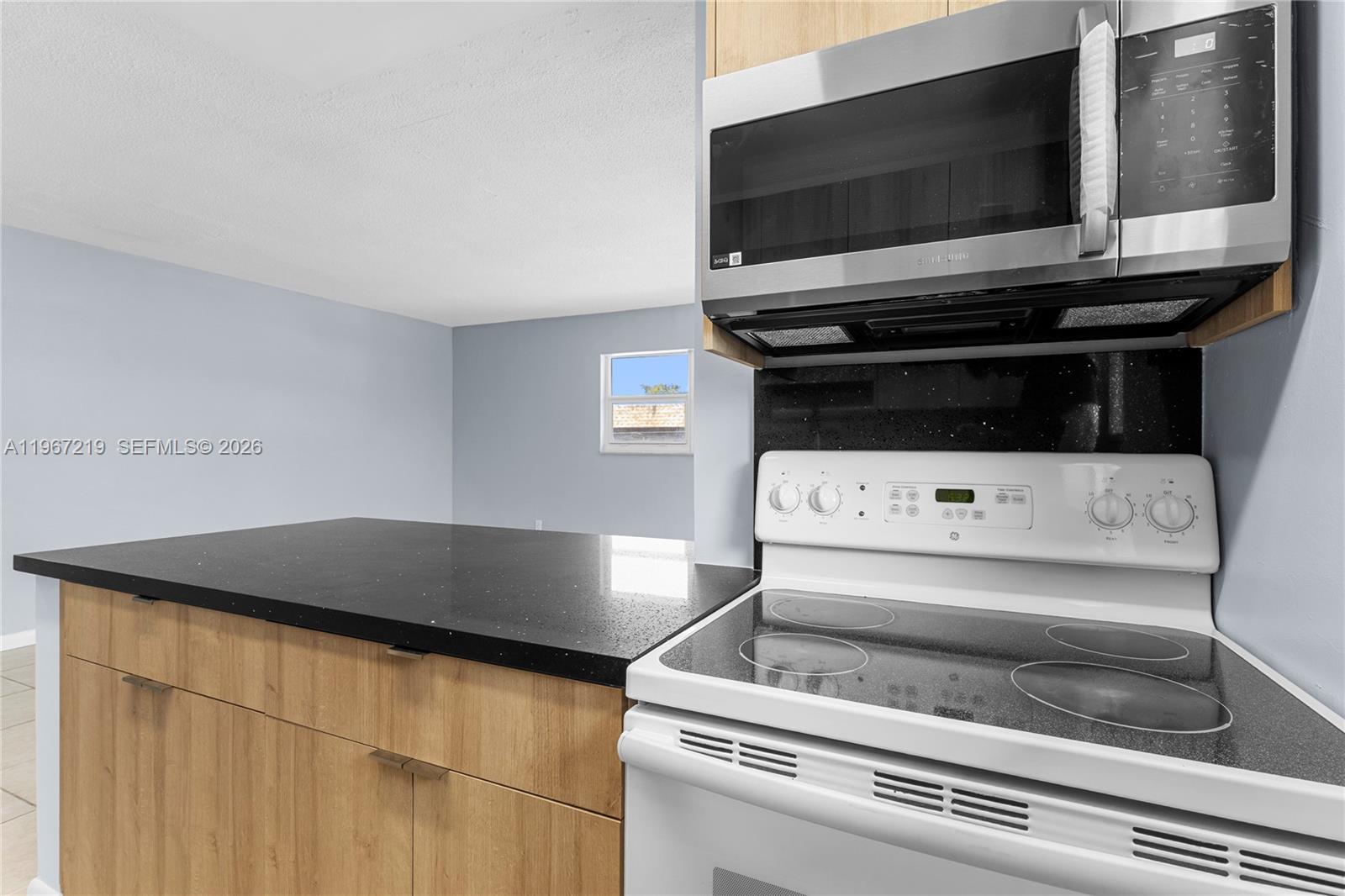 3265 Griffin Road, Unit 206 Dania Beach, FL 33312 - Photo 11 of 15 a kitchen with a stove and a microwave