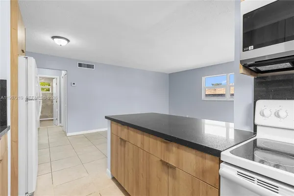 a kitchen with a sink and a stove top oven