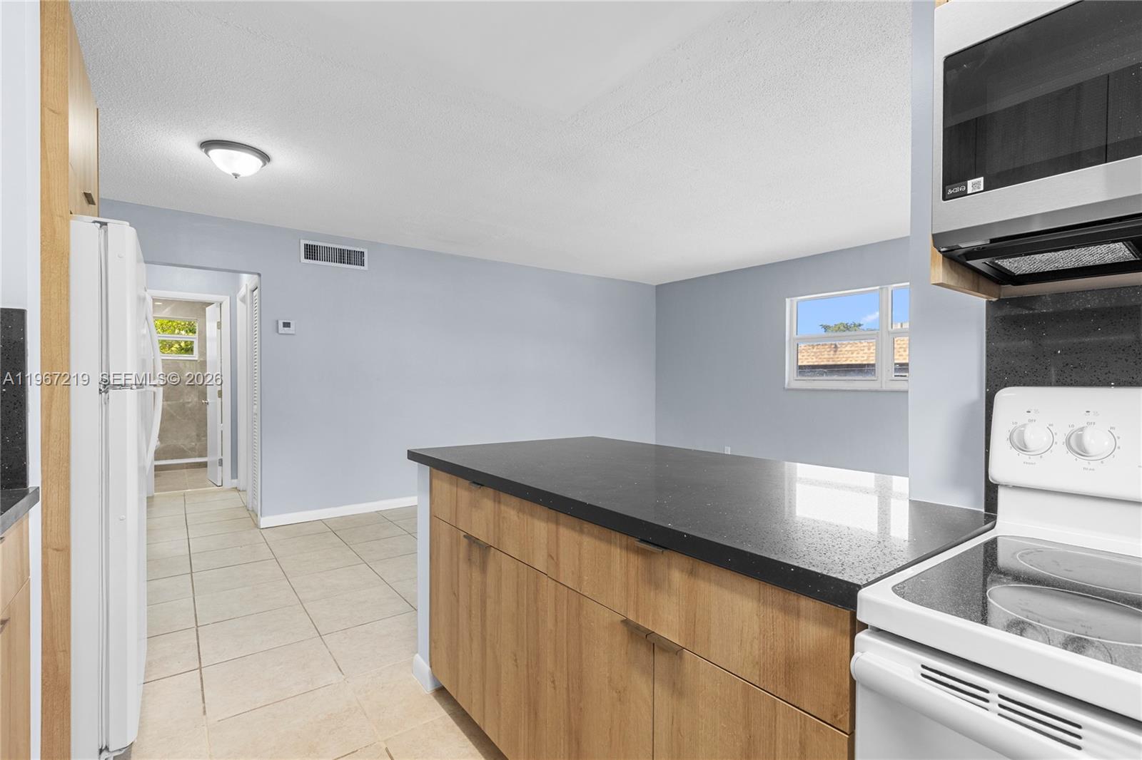 3265 Griffin Road, Unit 206 Dania Beach, FL 33312 - Photo 12 of 15 a kitchen with a sink and a stove top oven