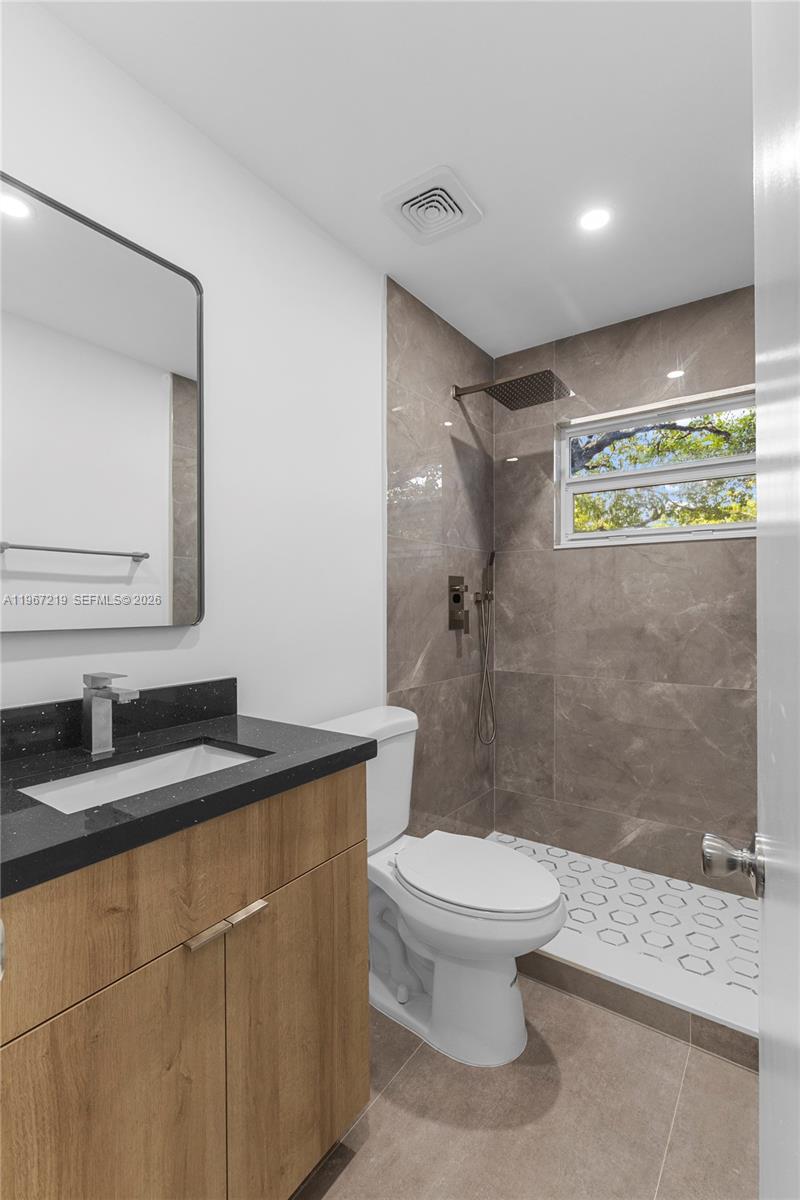 3265 Griffin Road, Unit 206 Dania Beach, FL 33312 - Photo 14 of 15 a bathroom with a granite countertop sink toilet and shower