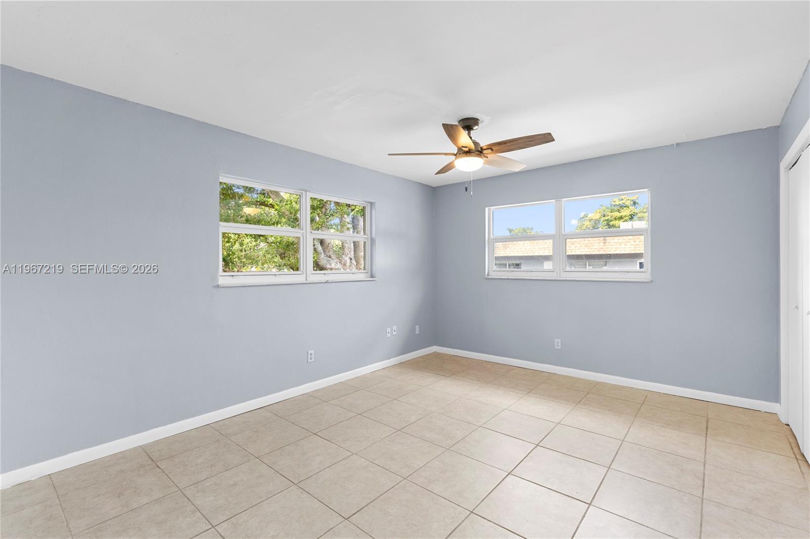 3265 Griffin Road, Unit 206 Dania Beach, FL 33312 - Photo 2 of 15 an empty room with windows and ceiling fan