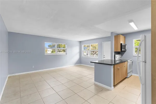 a kitchen with granite countertop a sink and cabinets