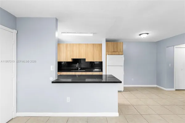 a kitchen with stainless steel appliances granite countertop a sink a stove and a refrigerator