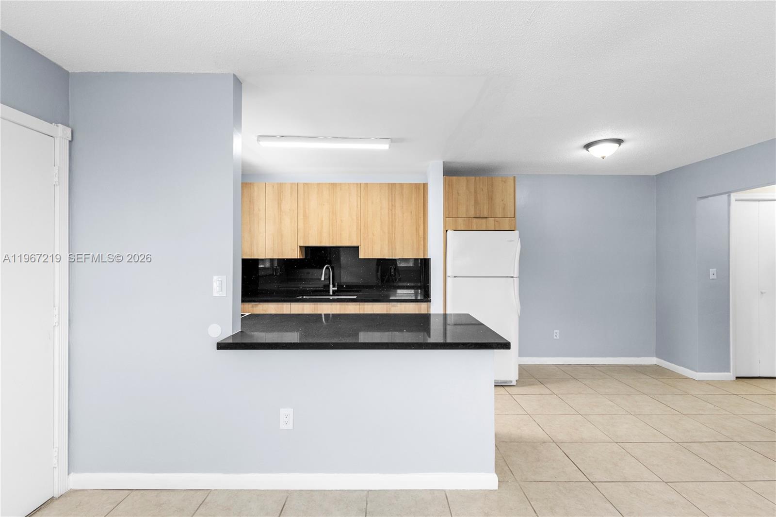 3265 Griffin Road, Unit 206 Dania Beach, FL 33312 - Photo 8 of 15 a kitchen with stainless steel appliances granite countertop a sink a stove and a refrigerator