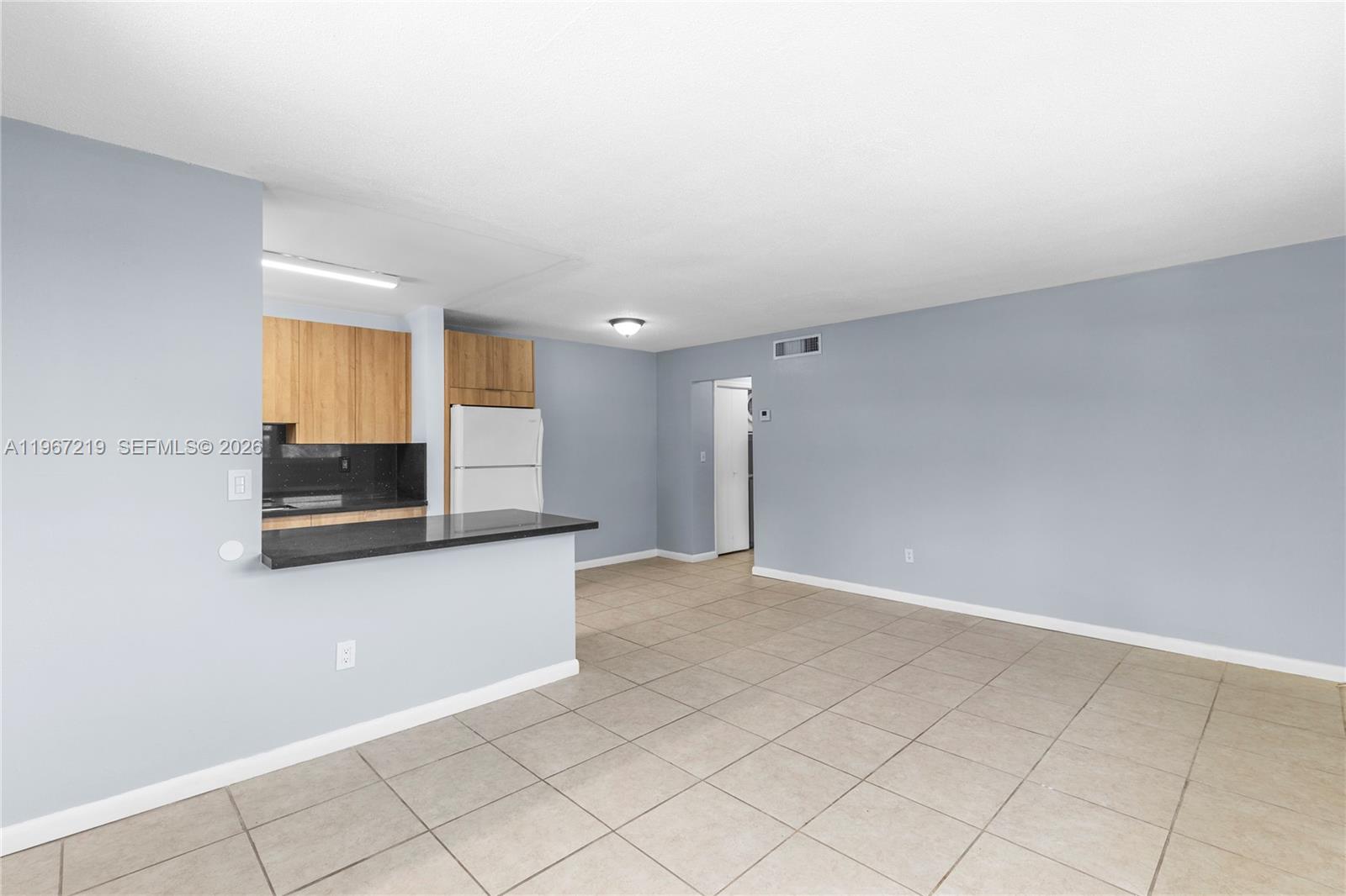 3265 Griffin Road, Unit 206 Dania Beach, FL 33312 - Photo 9 of 15 a view of a kitchen with an empty space and a sink