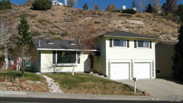 3575 Gibraltar Drive Reno, NV 89509 - Photo 1 of 1 a front view of a house with a yard and garage