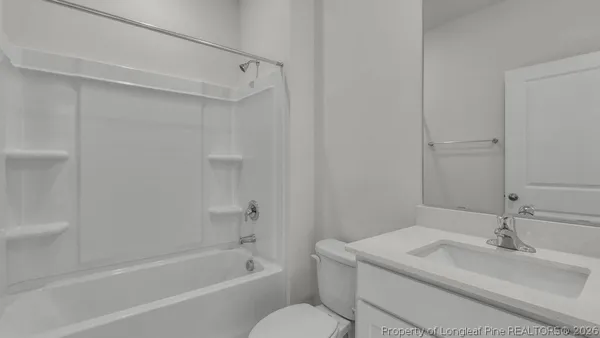 a bathroom with a sink toilet vanity and shower