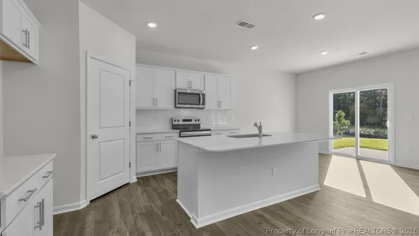 a kitchen with appliances a sink and cabinets