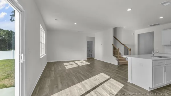 a view of kitchen and hall with wooden floor