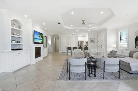 a living room with fireplace furniture and a flat screen tv