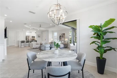 a view of a dining room with furniture wooden floor and chandelier