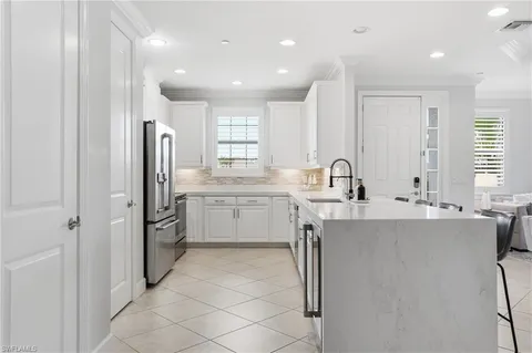a kitchen with appliances a sink and cabinets