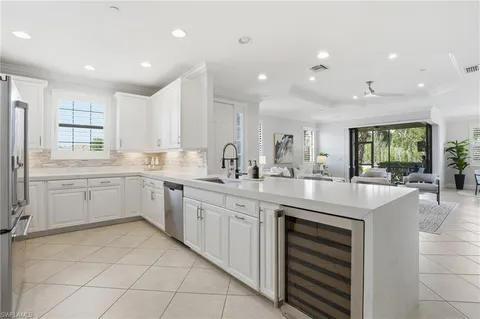a kitchen with a sink window and cabinets