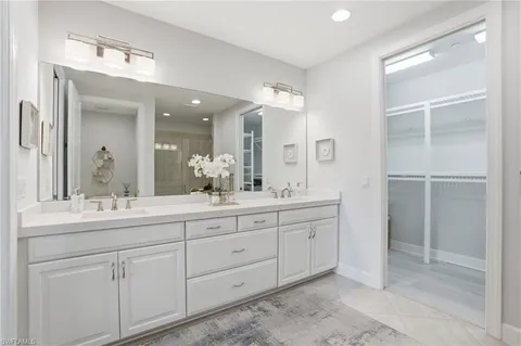 a bathroom with a double vanity sink and mirror
