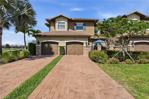 a front view of a house with a yard and garage