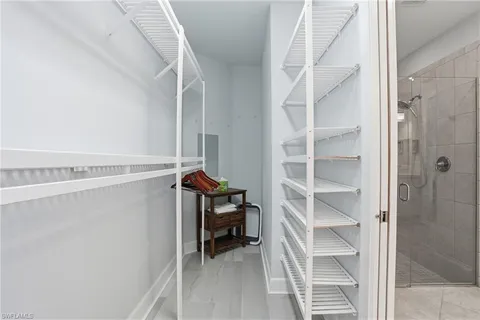 a view of walk in closet with empty racks