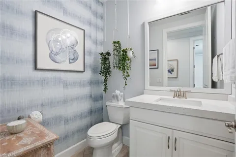 a bathroom with a toilet sink and vanity