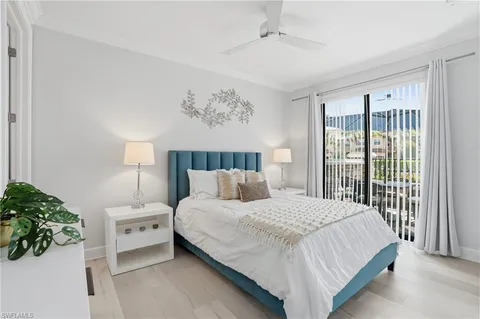 a bedroom with a large bed and a potted plant
