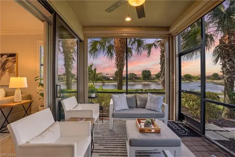 a living room with furniture and a floor to ceiling window