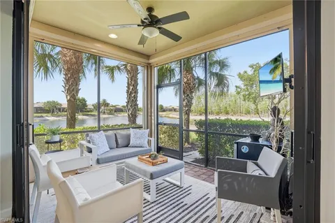 a living room with furniture and a floor to ceiling window