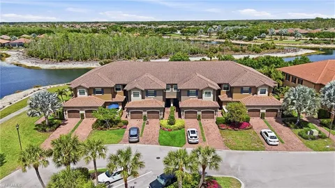 an aerial view of a house with a garden and lake view