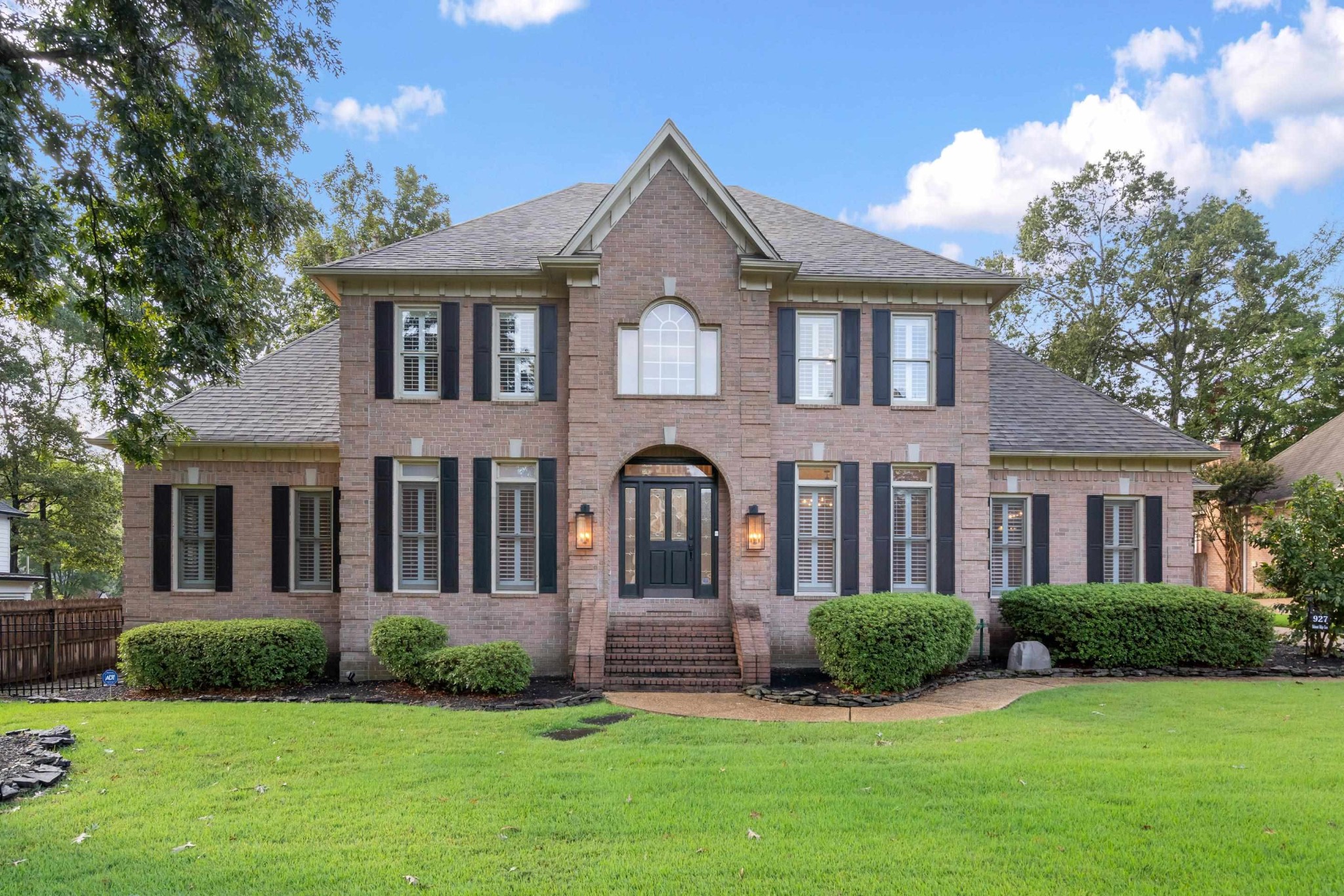 a front view of a house with a yard