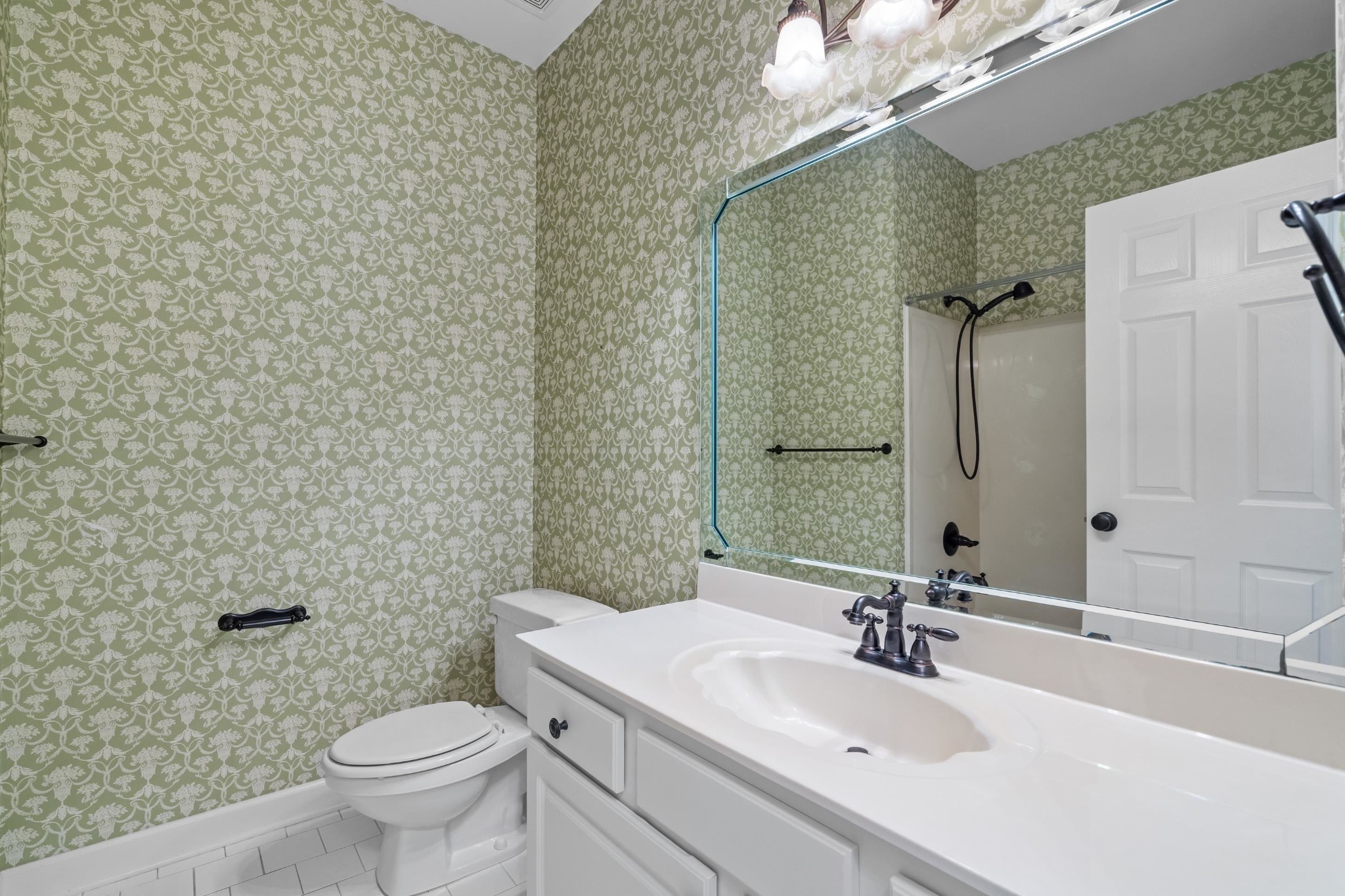 927 Oakmont Ridge Cove Collierville, TN 38017 - Photo 14 of 40 a bathroom with a sink a toilet and mirror